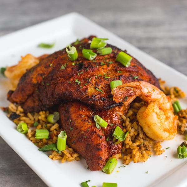 Soulé's blackened catfish and shrimp with dirty rice, garnished with chopped green onions.